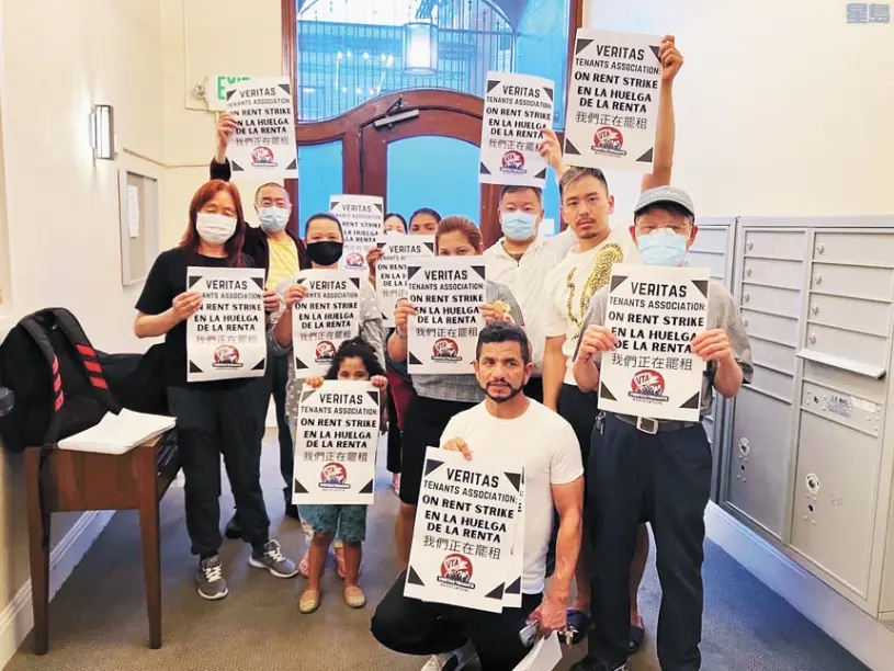 Photo of 781 Tenants with signs that read "On rent strike" in English, Spanish, and Chinese